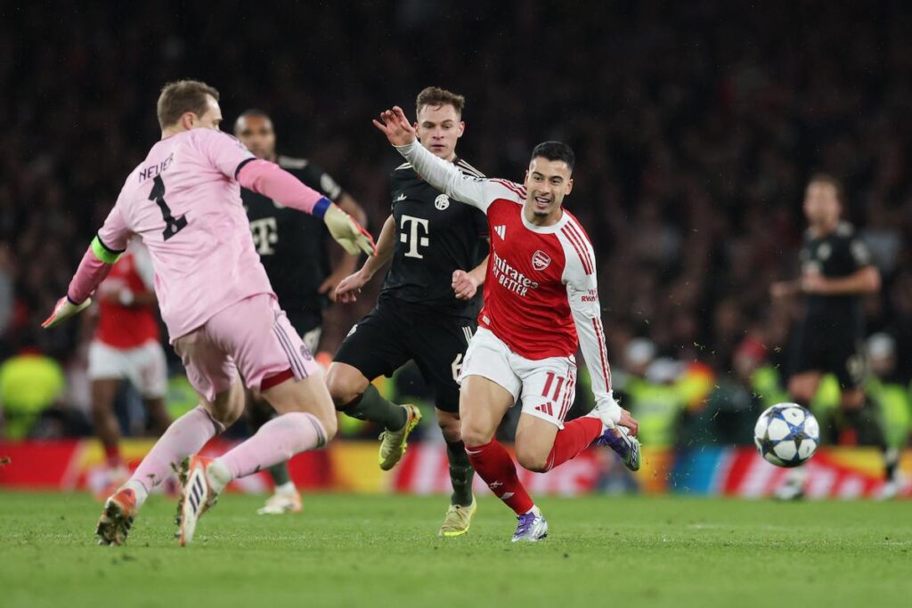 Gabriel Martinelli of Arsenal goes round Manuel Neuer of Bayern Munich to score his team's third goal
